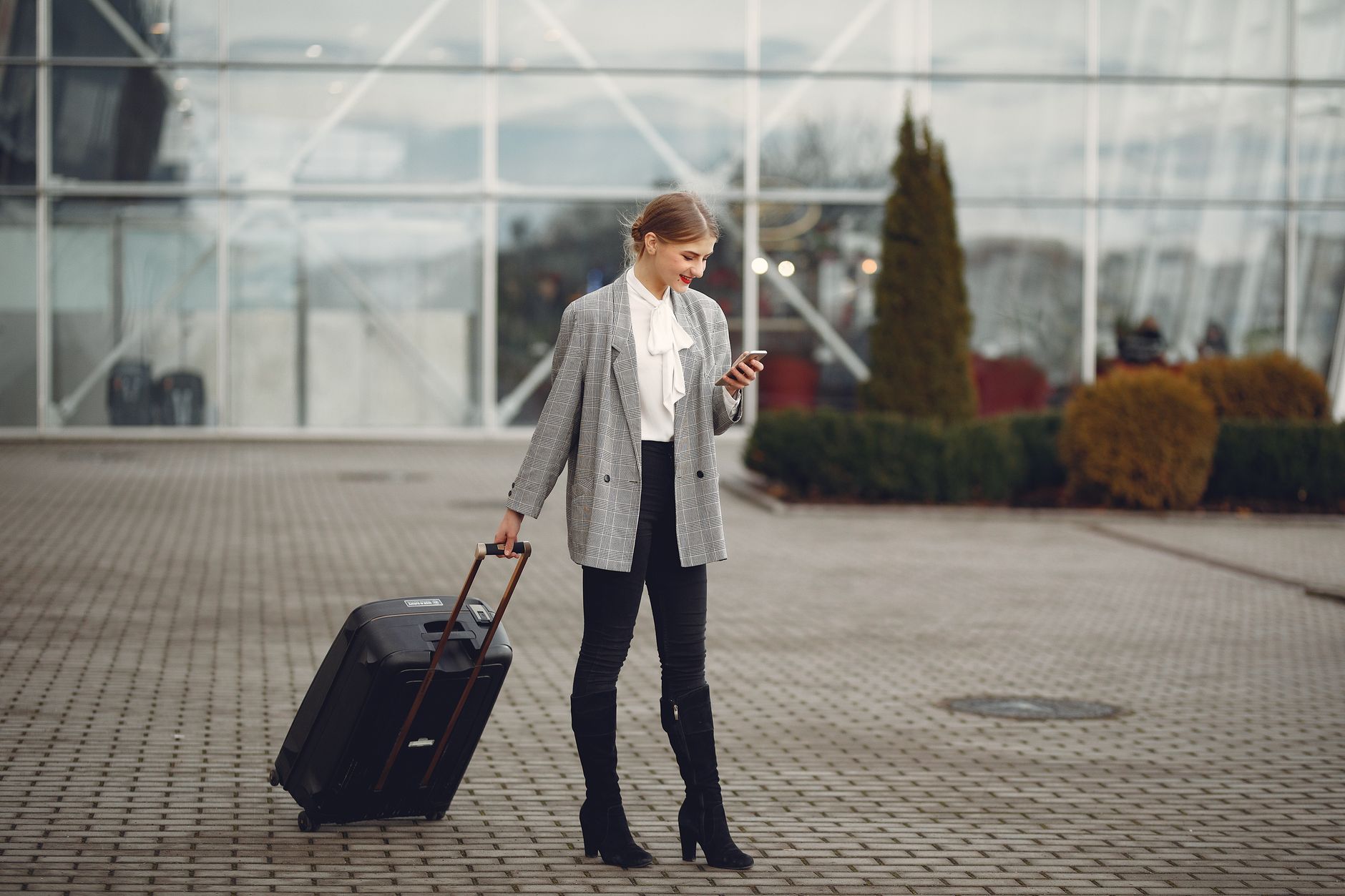 airport arrival hall traveler using smartphone